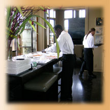 staff plating and serving a meal